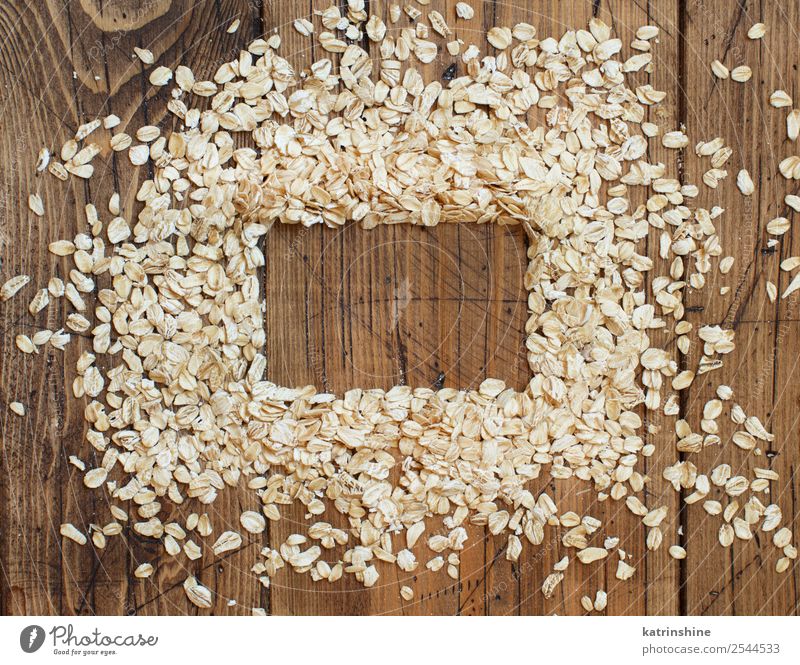 Draufsicht auf Haferflocken Ernährung Frühstück Vegetarische Ernährung Diät Sommer Natur Holz natürlich Hintergrund Müsli Essen zubereiten Flocken Lebensmittel