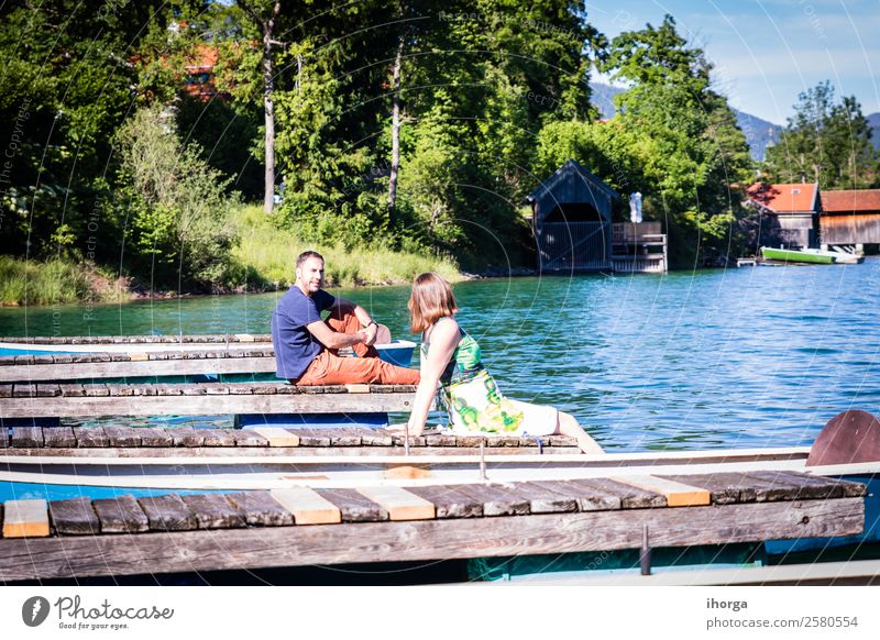 Zwei glückliche Liebende im Urlaub am Pier am See Lifestyle Glück schön Leben Erholung Ferien & Urlaub & Reisen Abenteuer Sommer Berge u. Gebirge Frau