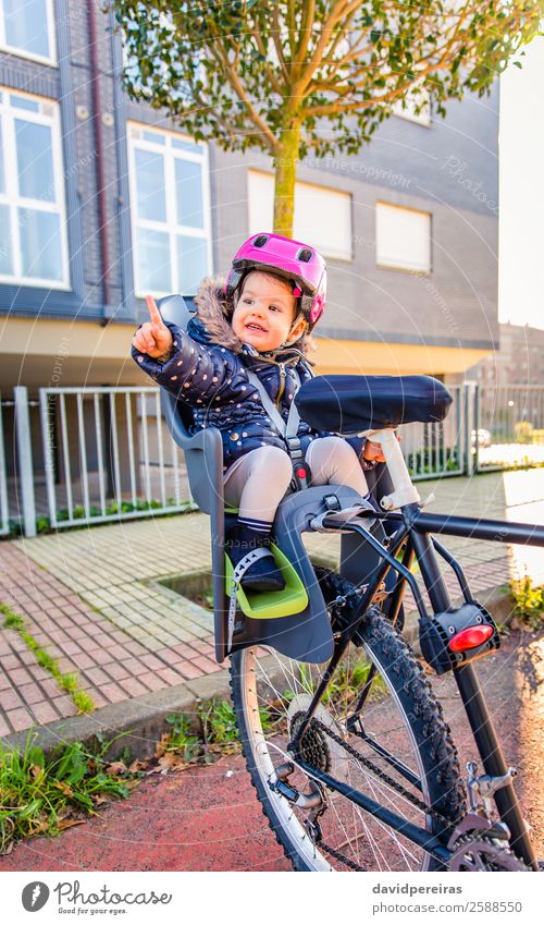 Kleines Mädchen mit Schutzhelm im Fahrradsattel sitzend Lifestyle Freizeit & Hobby Ferien & Urlaub & Reisen Ausflug Stuhl Sport Kind Baby Kleinkind Frau