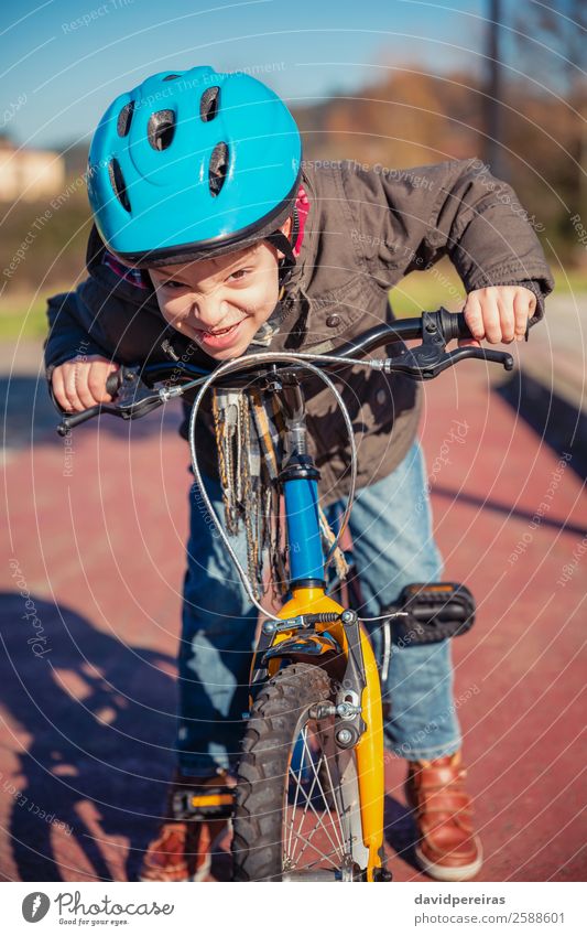 Ungezogener Junge mit trotziger Geste über seinem Fahrrad Lifestyle Glück Gesicht Freizeit & Hobby Spielen Sonne Winter Sport Fahrradfahren Kind Mensch Straße