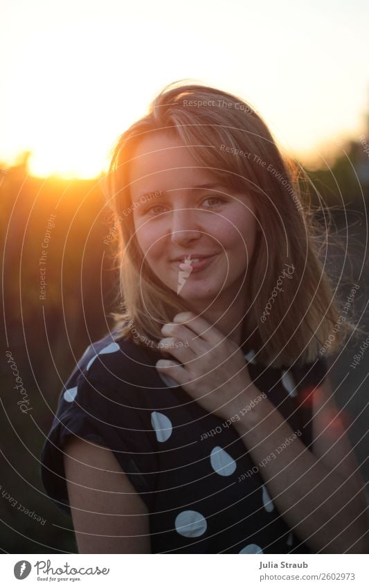 Sonnenuntergang Frau Schön T-Shirt brünett blond kurzhaarig Lächeln schön Wärme feminin orange Sommerabend Punkt Bluse Haare & Frisuren Farbfoto Außenaufnahme