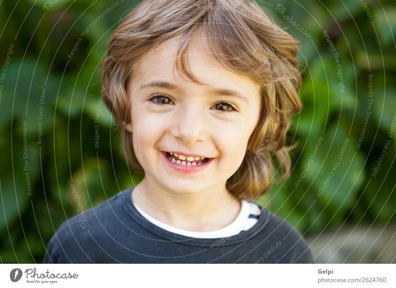 Entzückendes kleines Kind auf dem Feld mit Blick in die Kamera Freude Glück schön Gesicht Spielen Baby Junge Kindheit Natur Pflanze Baum Park Lächeln lachen