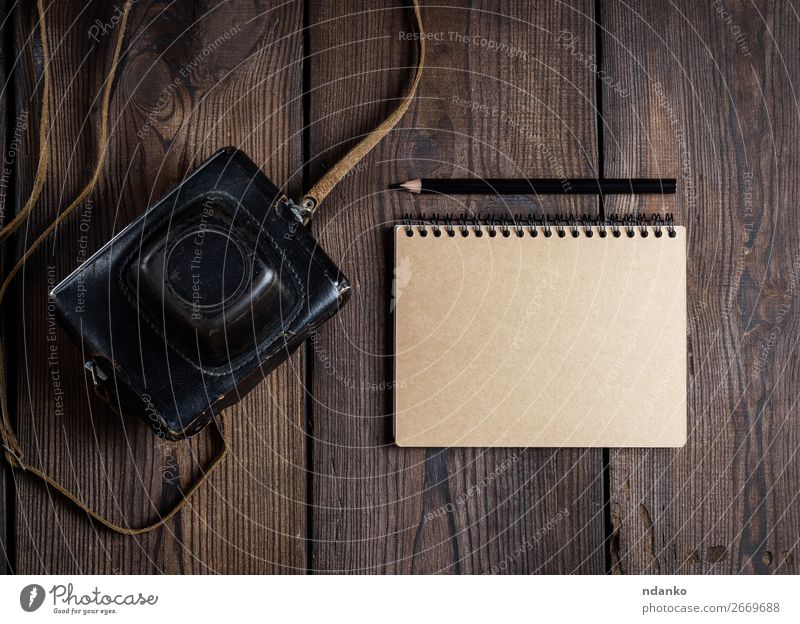 alte Vintage-Kamera in einer Ledertasche Tisch Fotokamera Technik & Technologie Papier Holz dunkel retro braun schwarz Hintergrund altehrwürdig Gerät Fotografie