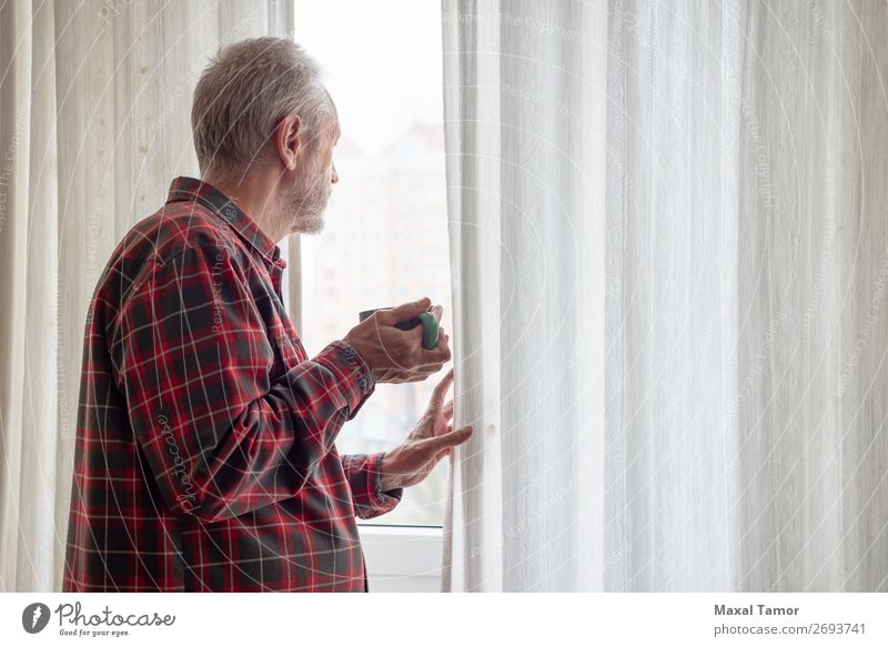 Ein erwachsener Mann trinkt seinen Kaffee und schaut aus dem Fenster. trinken Tee Mensch Erwachsene Stadt beobachten Denken stehen warten grün rot weiß