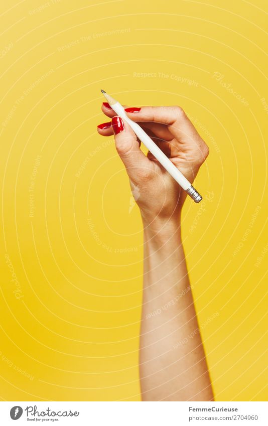 Forearm and hand with pencil against a yellow background feminin 1 Mensch Design gelb rot Nagellack Bleistift schreiben schreibend zeichnen Hand Finger Unterarm