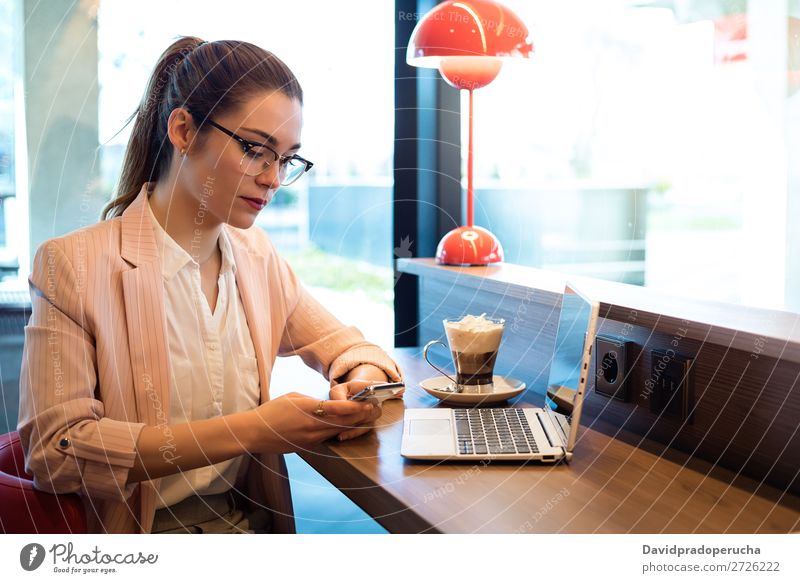 Junge schöne Frau mit Laptop, Smartphone und Kaffee in einem Restaurant. Notebook Telefon Mobile PDA Jugendliche Geschäftsfrau Lächeln Glück sprechen Computer