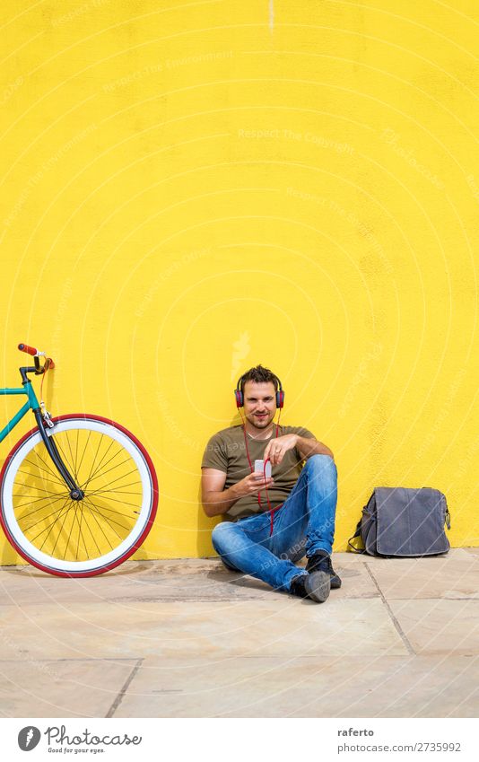 Die Frontansicht eines attraktiven Mannes sitzt auf dem Boden. Lifestyle Glück Erholung Musik Telefon Handy PDA Technik & Technologie Mensch maskulin