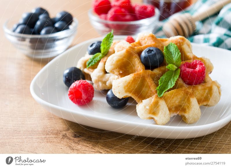 Traditionelle belgische Waffeln mit Heidelbeeren und Himbeeren Blaubeeren Minze Dessert süß Bonbon Frucht Gesundheit Gesunde Ernährung Frühstück Lebensmittel