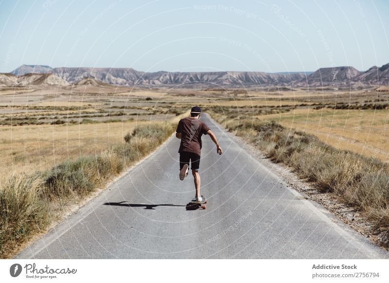 Mann fährt Skateboard auf der Präriestraße Straße Ferien & Urlaub & Reisen Lifestyle Mensch Erwachsene Natur Abenteuer Ausflug Tourist Landschaft Reiten