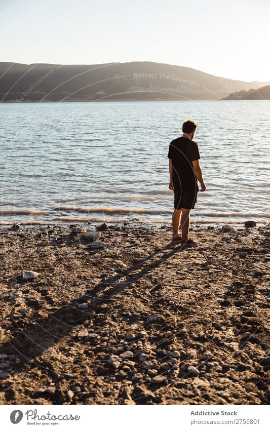 Mann, der am Strand posiert. Wasser Mensch Ferien & Urlaub & Reisen Natur Erholung Meer See aussruhen ruhig Gelassenheit friedlich dunkel tief nass kalt