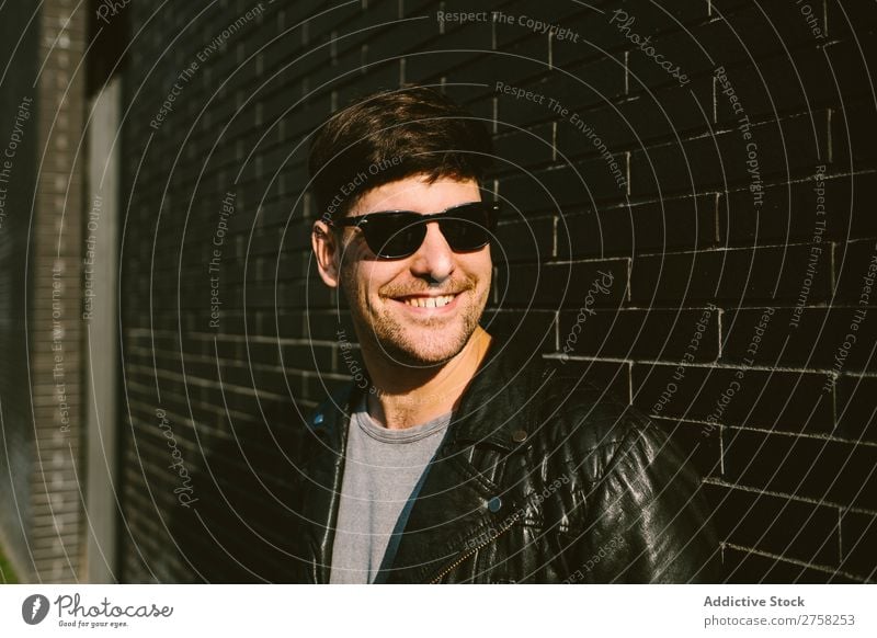 Fröhlicher Mann mit Sonnenbrille heiter Lächeln Glück selbstbewusst jung cool Person Porträt modern Model modisch männlich ernst lässig gutaussehend Typ