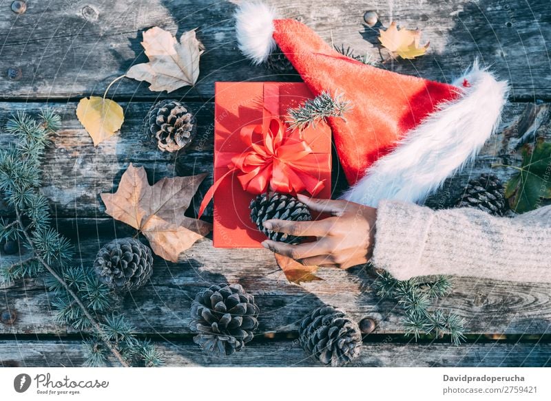 Frau Arme machen Weihnachtsdekoration in einem Holztisch im Freien Weihnachten & Advent Geschenk Hut Weihnachtsmann Leben Stillleben Hand Hintergrundbild