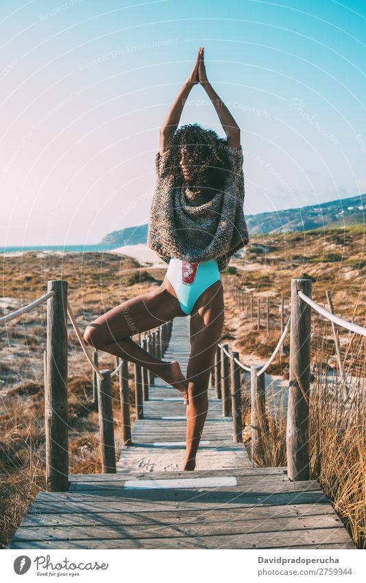 Junge schwarze Frau beim Yoga in einer hölzernen Fußgängerbrücke am Strand Hintergrundbild Bikini üben Brücke Küste krause Haare Ausflugsziel Behaarung