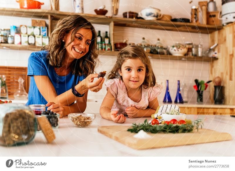 Kleines Mädchen kocht mit ihrer Mutter in der Küche. kochen & garen Koch Schokolade Speiseeis Tochter Tag Glück Freude Familie & Verwandtschaft Liebe backen