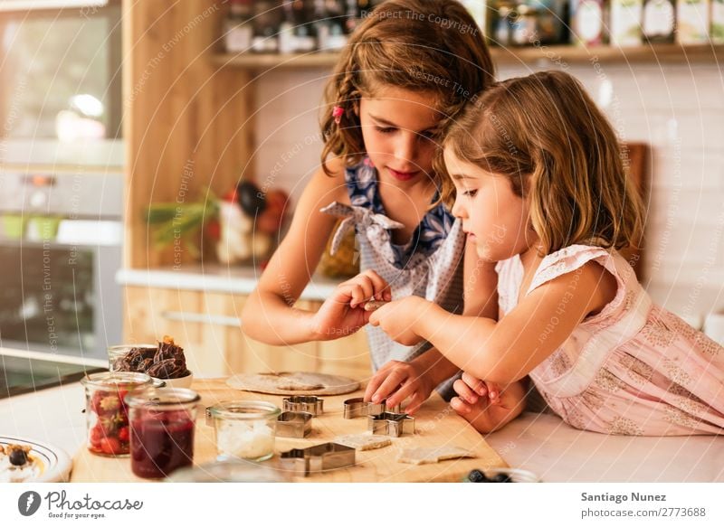 Kleine Schwestern Mädchen bereitet das Backen von Keksen vor. Kind kochen & garen Koch Küche Schokolade Speiseeis Erdbeeren Tochter Tag Glück Freude