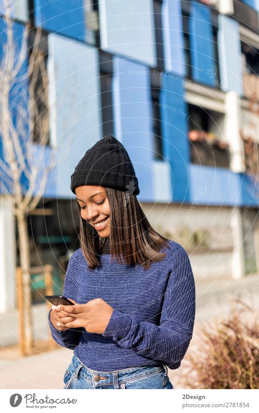 Glückliche Frau mit Hut in der City Street, während sie Technologie einsetzt. Stil schön Haare & Frisuren PDA Technik & Technologie Mensch feminin Junge Frau