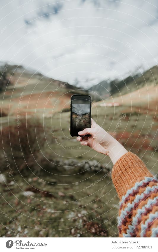 Frau fotografiert mit dem Smartphone das Tal mit hohen Hügeln bei bewölktem Wetter. PDA Wolken Pyrenäen Fotografie nehmen Dame Handy Schießen Berge u. Gebirge