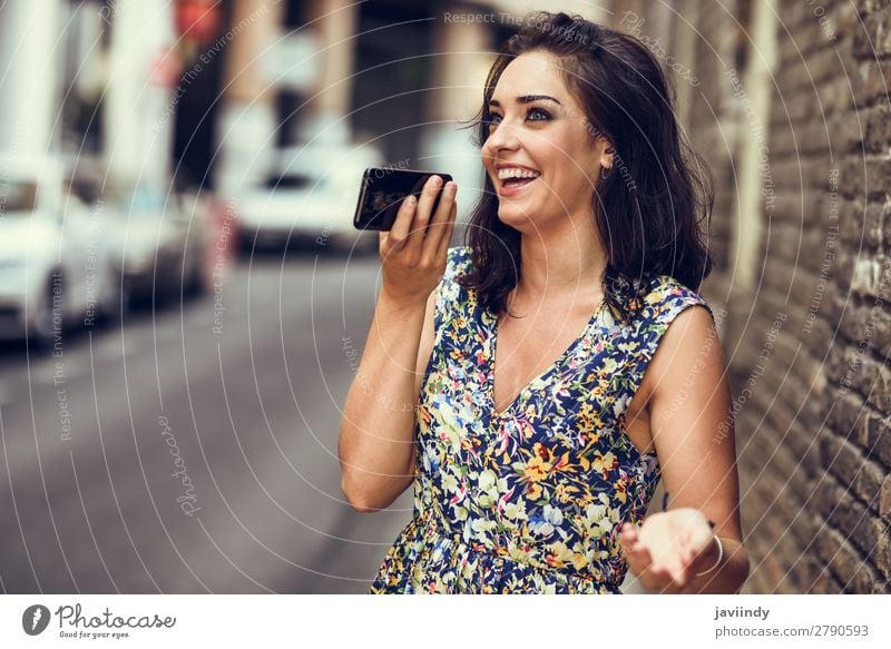 Lächelnde junge Frau nimmt Sprachnotiz in ihrem Smartphone auf. Lifestyle Stil Glück schön Haare & Frisuren Telefon PDA Technik & Technologie Mensch feminin