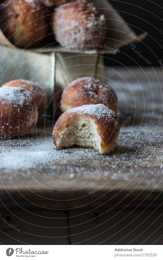 Gebackene Kuchen in Bastelpapier auf dem Tisch Handwerk Papier Brotlaib Zucker gepulvert Dunkelheit Lebensmittel Backwaren Kulisse Mahlzeit Bäckerei süß Dessert