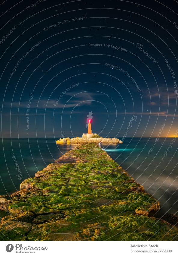 Grober Weg zur hellen Bake am Abend Wege & Pfade Leuchtturm Meer Inselchen rau Stein Himmel Ferien & Urlaub & Reisen Wasser faro villajoyosa Spanien Glanz Licht