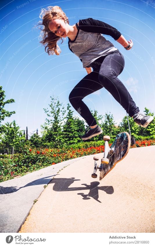 Skateboarderin, die Ollie im Park übt. asiatisch Aktion Außenaufnahme Sonnenlicht Rampe Skateboarding verpflichtet entschlossen Bewegung Mensch 1 Frau Energie