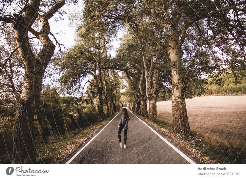 Frau, die auf der Landstraße geht. Straße Feld Ferien & Urlaub & Reisen Landschaft Frischluft Geröll retro Gras regenarm Natur Weg Wege & Pfade Autobahn schön