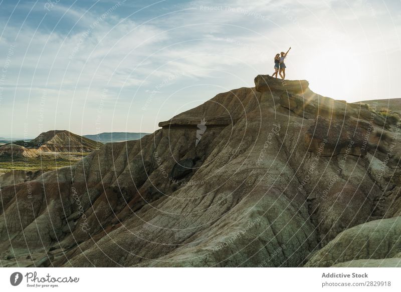 Frauen, die auf einer Klippe posieren. Aufregung stehen Hände hoch Freiheit Ferien & Urlaub & Reisen Erfolg Top Berge u. Gebirge Jugendliche Natur Felsen