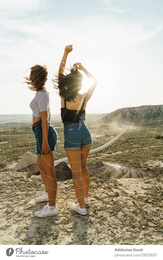 Fröhliche Frauen, die auf einer Klippe stehen. Aufregung heiter Umarmen Freiheit Ferien & Urlaub & Reisen Erfolg Top Berge u. Gebirge Jugendliche Natur Felsen