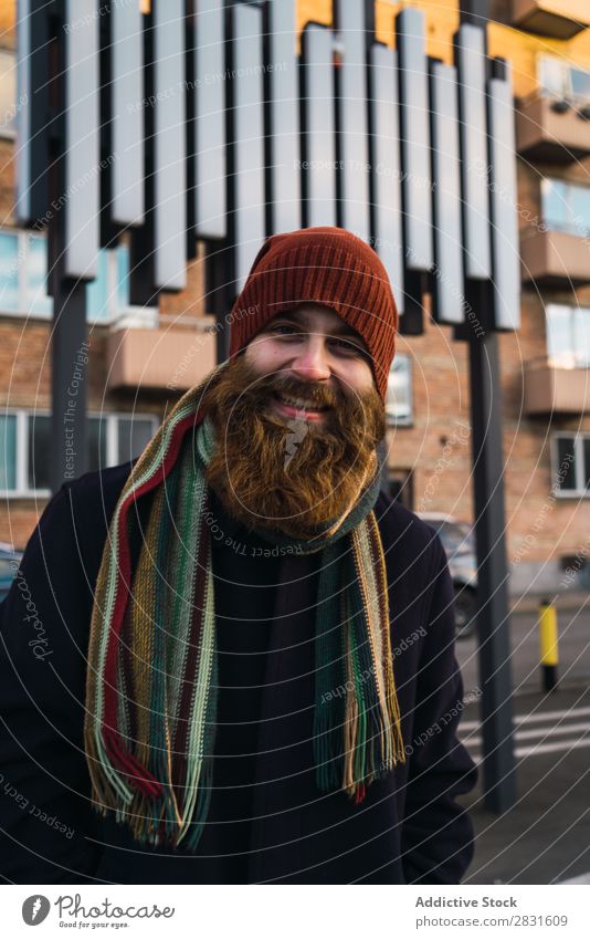 Fröhlicher bärtiger Mann auf der Straße gutaussehend heiter Lächeln Vollbart Blick in die Kamera Großstadt Jugendliche Stadt Lifestyle lässig Mode Stil