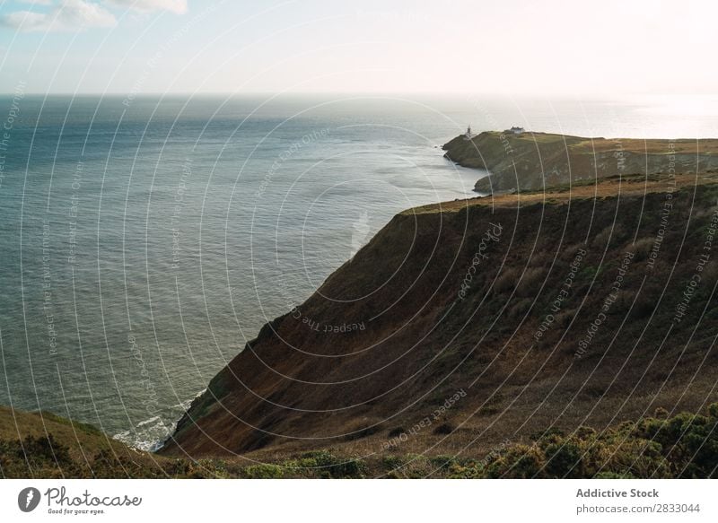 Großer Küstenfelsen und ruhiges Meer Seeküste Felsen Landschaft Strand Natur Wasser natürlich Meereslandschaft Stein schön grün Gras Ferien & Urlaub & Reisen