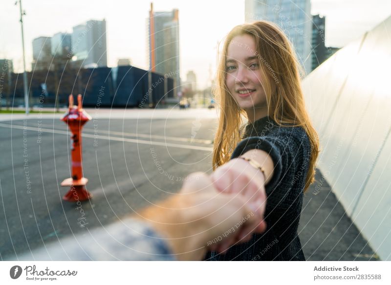 Junge süße Frau. Folgen Sie dem Konzept. mir folgen gestikulieren Lächeln heiter verträumt Gebäude Hand Straße Großstadt urban in die Kamera schauen hübsch jung