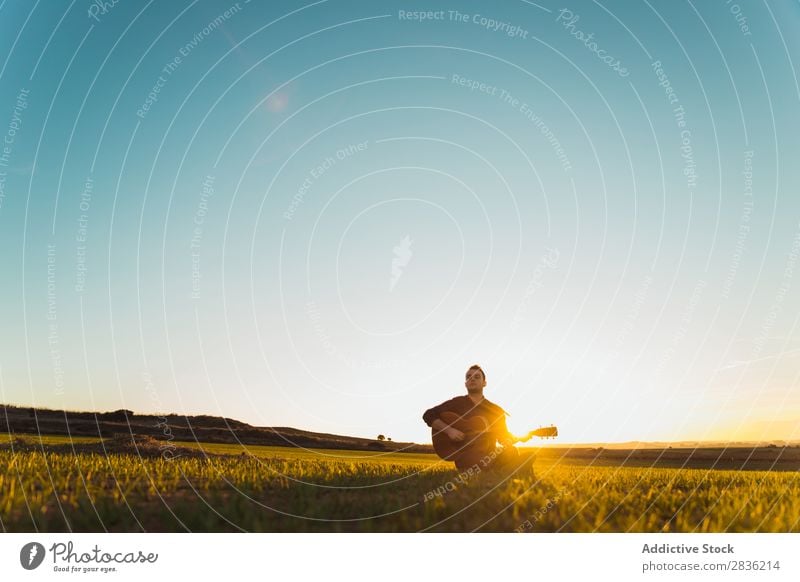 Mann mit Gitarre auf dem Feld Natur Musik Lifestyle Musiker lässig Gitarrenspieler akustisch grün laufen Musical Mensch Typ natürlich Instrument Spielen Stil