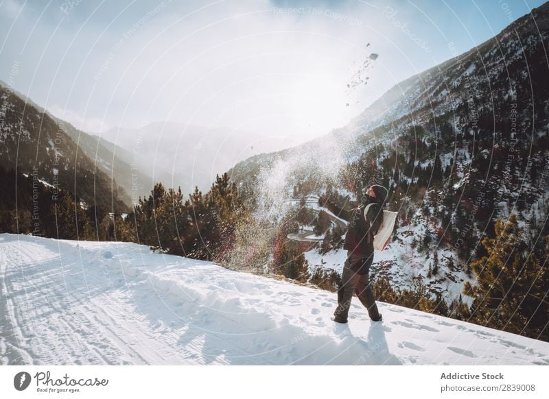 Mann, der Schnee wirft. Mensch Tourist Rucksack Winter Hügel Berge u. Gebirge Landschaft Natur weiß Eis Jahreszeiten kalt Ferien & Urlaub & Reisen Weg Frost