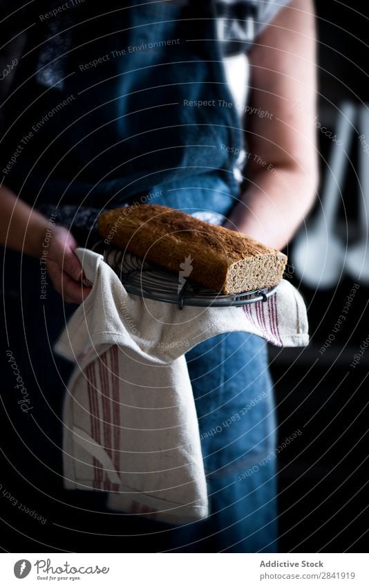 Frau, die einen selbstgemachten Kuchen mit Stoff hält. Küchenchef Halt Hand Dessert gebastelt Pasteten Lebensmittel frisch Scheibe Biskuit süß lecker Zucker