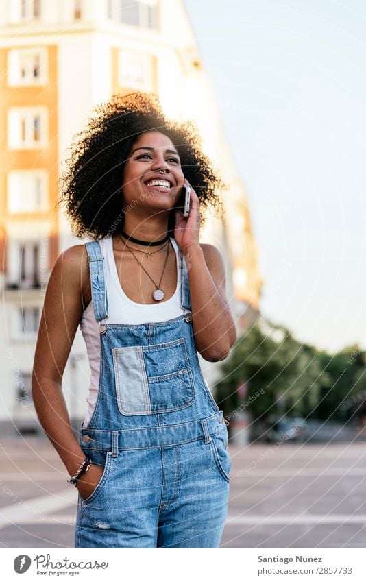 Schöne Frau mit Handy auf der Straße. Telefon schwarz Afrikanisch Mobile PDA Sprechen Afro-Look Mensch Porträt Großstadt Jugendliche Mädchen Amerikaner Lächeln