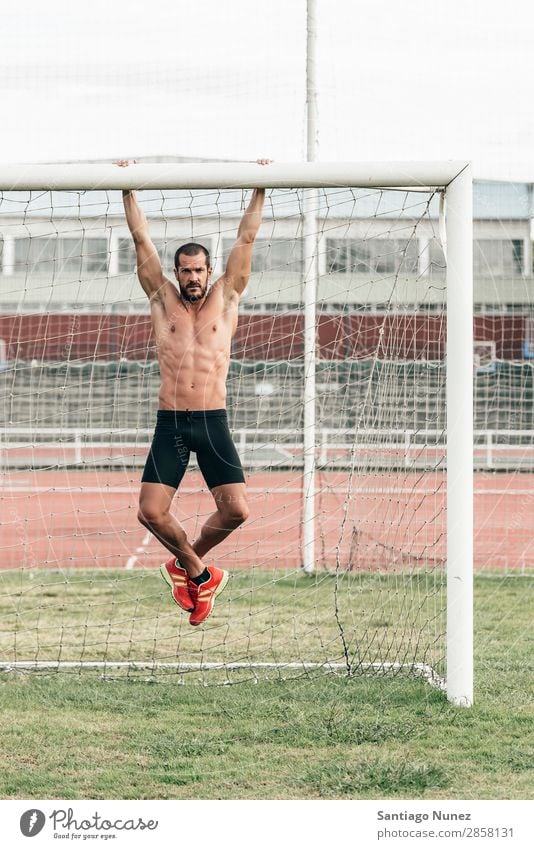 Mann macht Chin-ups im Freien. Bauchmuskeln Aktion Athlet attraktiv Kinn-up üben sportlich Fitness Torpfosten grün Sporthalle gutaussehend Gesundheit horizontal