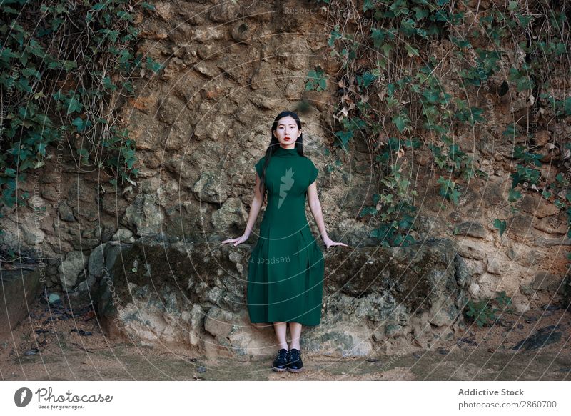 Hübsche asiatische Frau am Teich sitzend Jugendliche attraktiv Kleid rot lügen Bank Holz Blick in die Kamera schön Beautyfotografie Mensch hübsch Dame Porträt