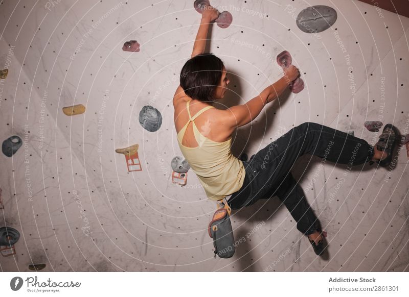 Junge Frau beim Klettern an der Wand Fitness Sporthalle Griffe Sportbekleidung Dame Jugendliche gymnastisch sportlich Aktion Training Körper Lifestyle