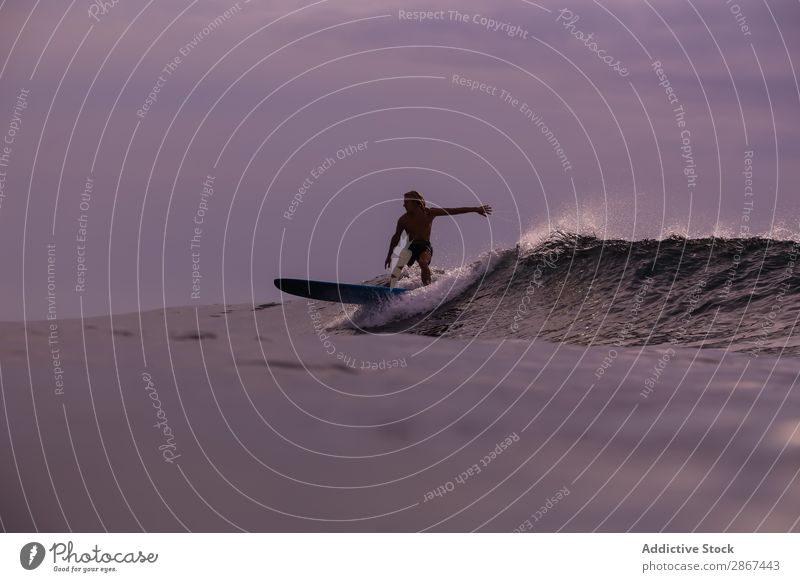 Mann auf dem Surfbrett auf winkendem Wasser bei Sonnenuntergang Oberfläche Sport Bali Indonesien platschen Surfen Himmel Meer Himmel (Jenseits) Abend