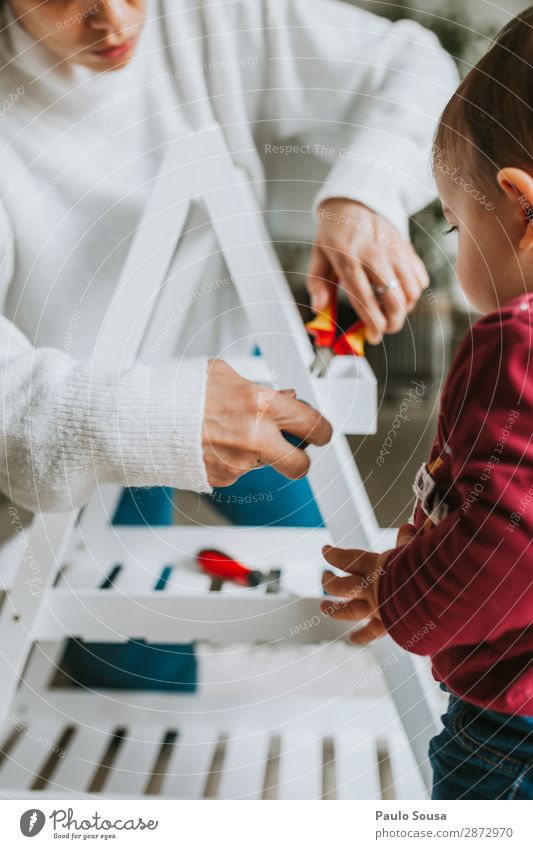 Frau, die Möbel zu Hause mit der Tochter zusammenbaut. Lifestyle heimwerken Hausbau Umzug (Wohnungswechsel) einrichten Innenarchitektur Dekoration & Verzierung