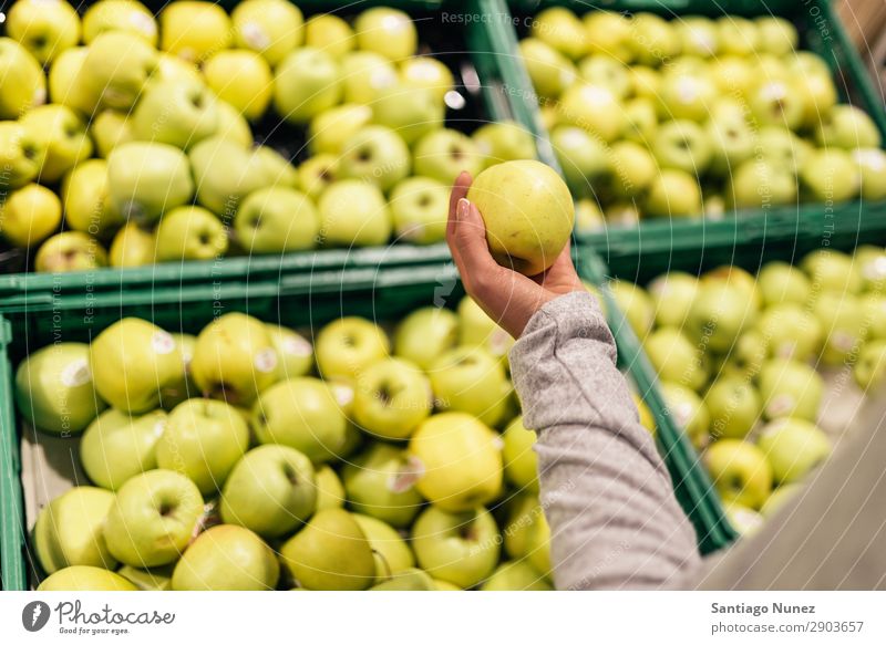 Schöne Frau, die Äpfel im Supermarkt auswählt. Frucht Nahaufnahme Lager Mensch Apfel Markt auserwählend Lebensmittel Hand Gesundheit frisch Halt kaufen