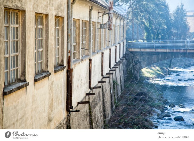 alte Fabrik Umwelt Natur Bach Fluss Industrieanlage Mauer Wand Fassade Fenster blau gelb Farbfoto Außenaufnahme Menschenleer Tag Schwache Tiefenschärfe