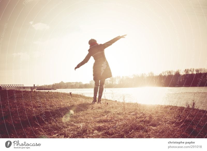 free Leben feminin Junge Frau Jugendliche Erwachsene 1 Mensch Wolkenloser Himmel Herbst Winter Schönes Wetter Küste Flussufer Jacke Mantel Tanzen Freude