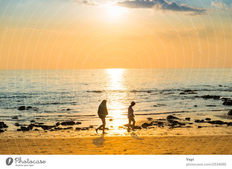 Sonnenuntergangslandschaft mit Strand, Sonne und Steinen am Meeresufer schön Sommer Mensch Frau Erwachsene 2 Natur Landschaft Sand Himmel Wolken Horizont