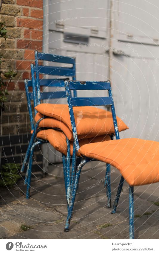 Empty chairs society Häusliches Leben Innenarchitektur Stuhl Haus Mauer Wand Tür kuschlig retro blau orange altehrwürdig Stil trendy shabby chic Kissen bequem