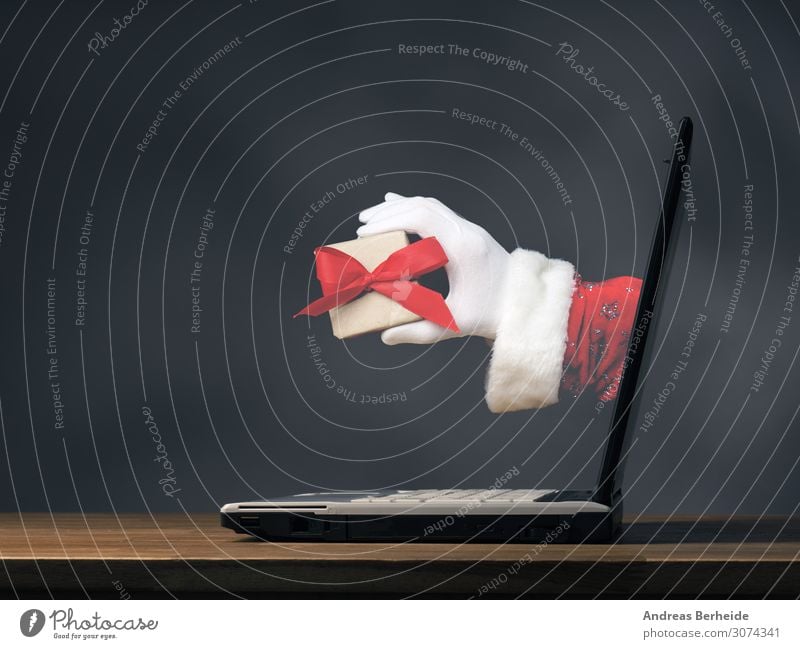 Hand of Santa with a gift box Winter Veranstaltung Weihnachten & Advent Notebook Internet Mensch Tradition online Weihnachtsmann modern ecology Hintergrundbild