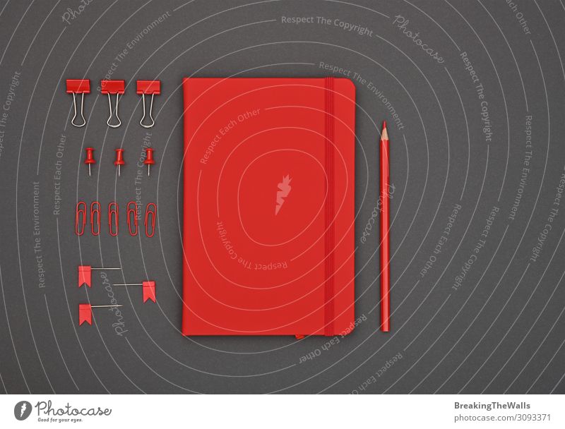 Ordentlich organisiertes rotes Briefpapier flach auf grau gelegt Schreibtisch Tisch Arbeitsplatz Büro Schreibwaren Papier dunkel modern oben schwarz Farbe