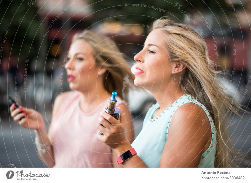 Hübsche Schönheitsfrauen mit elektrischem Zigarrenvaping Dampf Lifestyle elegant schön Freizeit & Hobby Technik & Technologie Mensch Frau Erwachsene Hand Straße