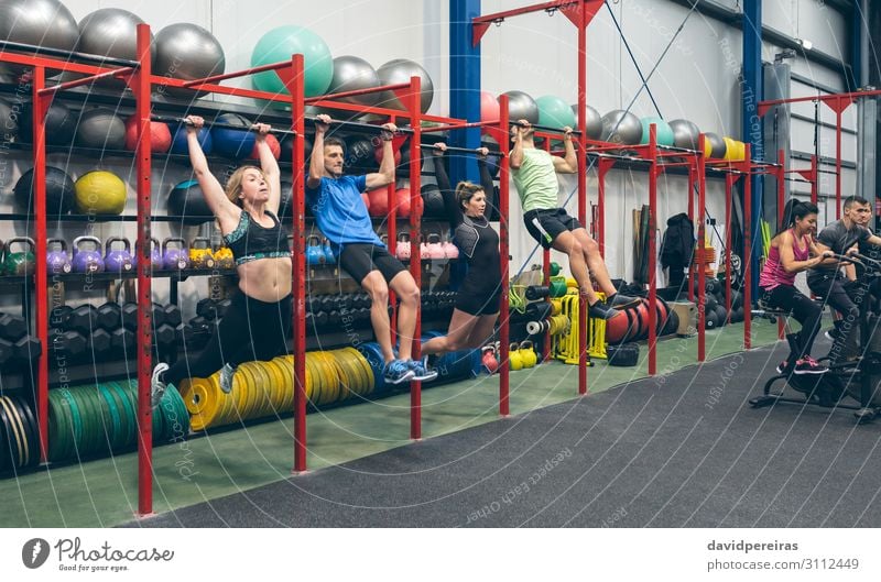 Athleten, die Pull-Ups machen und Airbike in der Turnhalle. Sport Ball Mensch Frau Erwachsene Mann Menschengruppe Fitness authentisch Klimmzüge kippen