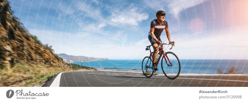 Mature Adult on a racing bike climbing the hill coastal road Ferien & Urlaub & Reisen Sommer Strand Sport Mensch Natur Autobahn Fitness bicycle cycling sky